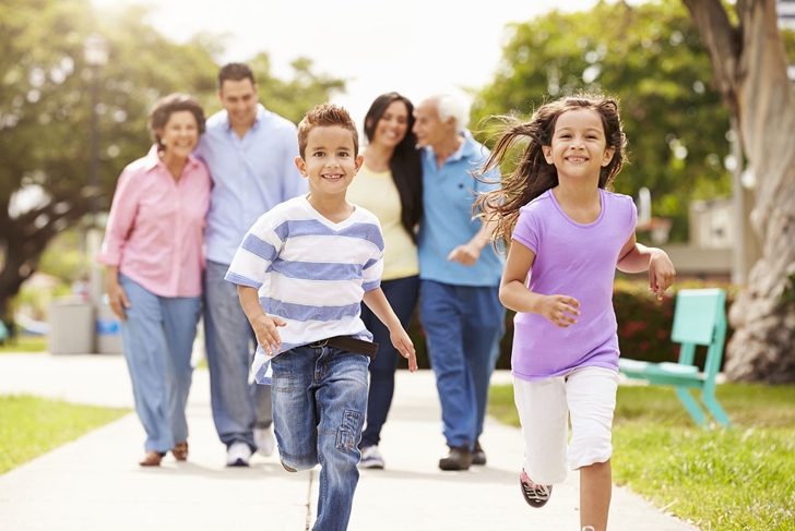 Multi Generation Family Walking In Park Together